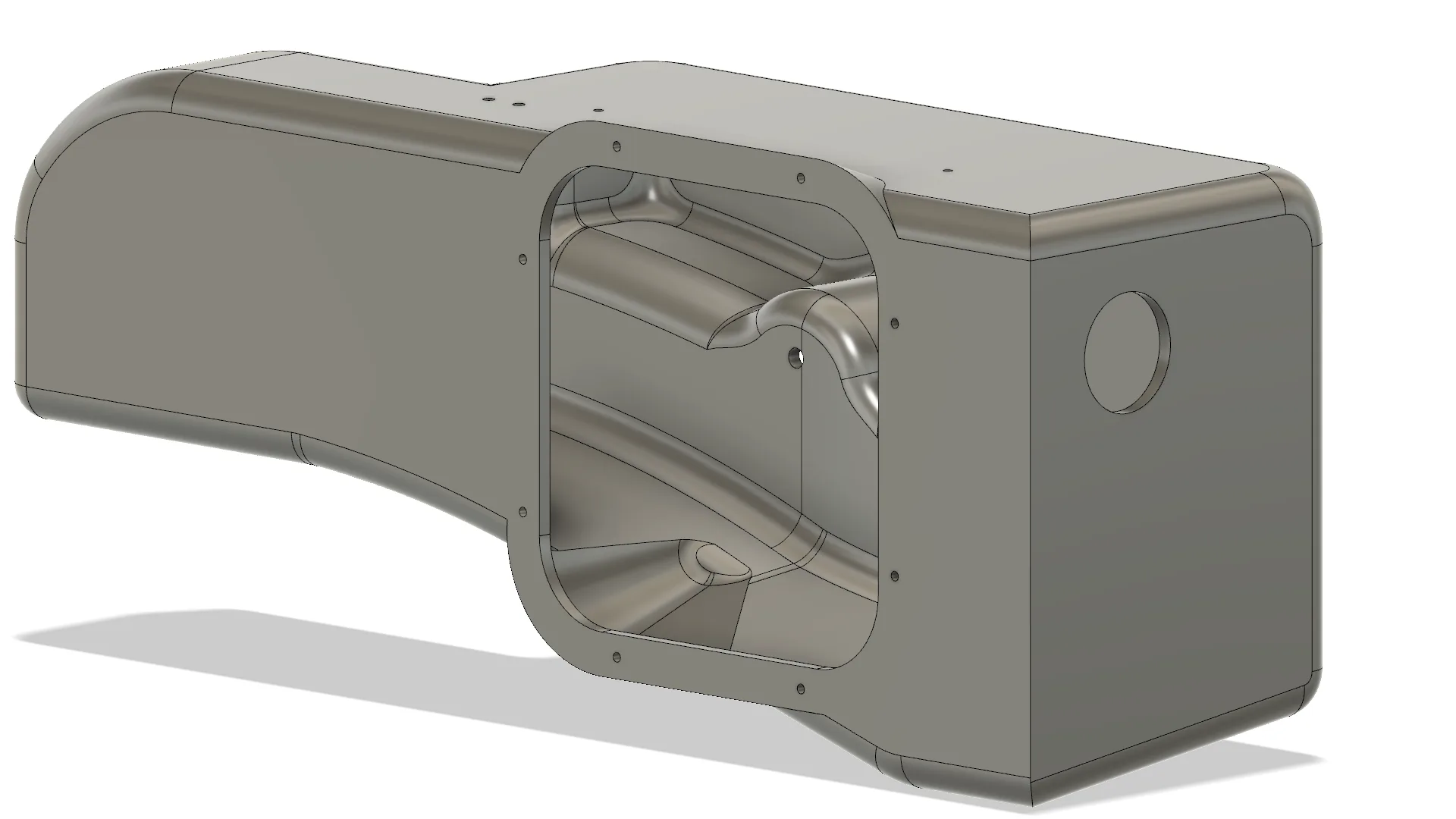 Rectangular metal casing with intricate inner design and circular cutout on the side, set against a white background.